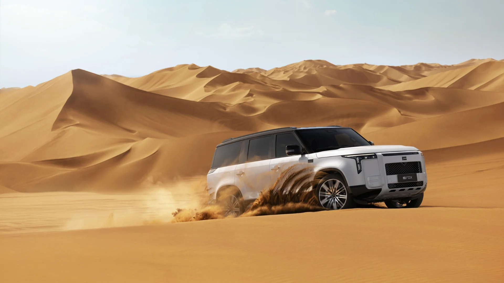 A white ROX SUV carving through desert dunes